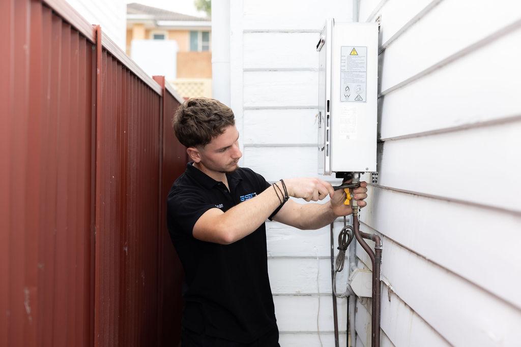 GSK Plumbing Solutions plumber servicing a hot water system in Sydney